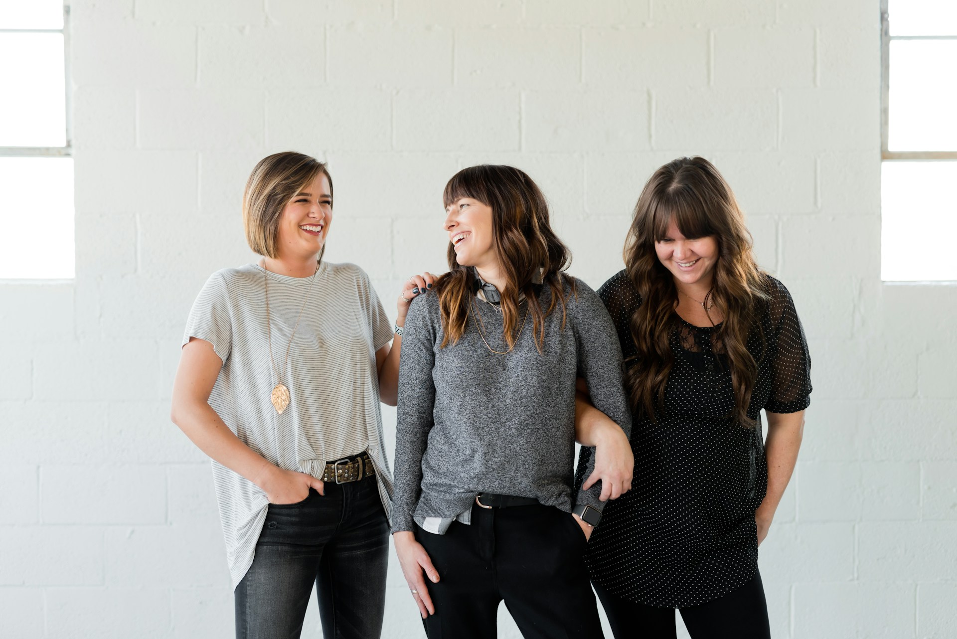 Three people laughing together