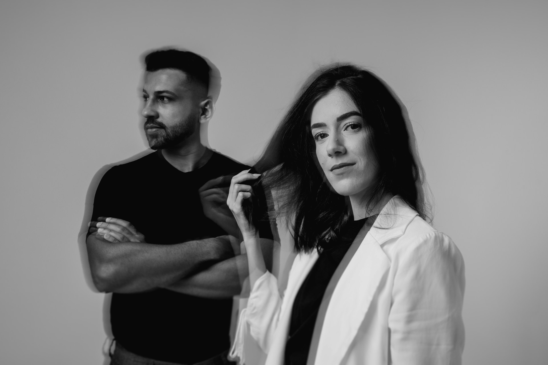 A man and a woman dressed in black and white with a blurry effect.